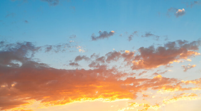 Beautiful colorful sunset sky with orange clouds. Nature sky background. © Inga Av