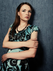 woman in a blue dress posing on a blue background