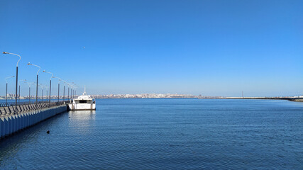 Fototapeta na wymiar Sea view from Baku city boulevard and Caspian sea. Beautiful sea boulevard scenery in Baku