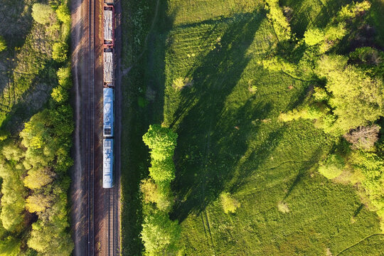Aerial view of cargo train, a double-track railway in countryside