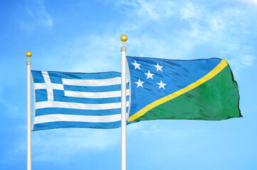 Greece and Solomon Islands two flags on flagpoles and blue sky