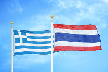 Obraz premium Greece and Thailand two flags on flagpoles and blue sky