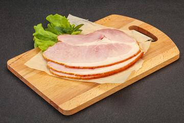 Sliced pork belly over board