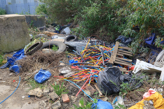 A pile of cable scraps and tyres dumped by the side
