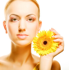 Beautiful young woman with gerber flower