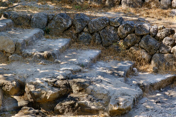 Old stone staircase and wall in the archeological site