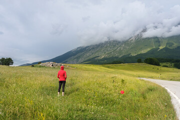 woman looking at the landscape in the san leonardo pass on the majella mountain area in abruzzo
