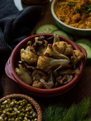 Roasted cauliflower in rustic natural light setting.
