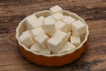 Refined white sugar cubs in the bowl