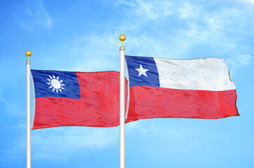 Taiwan and Chile two flags on flagpoles and blue sky