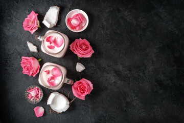 A group of moon milk glasses with roses on dark concrete with a copy of space.