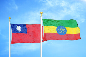 Taiwan and Ethiopia two flags on flagpoles and blue sky