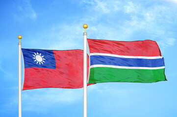 Taiwan and Gambia two flags on flagpoles and blue sky