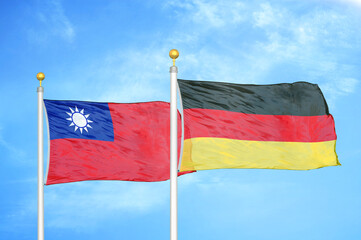 Taiwan and Germany two flags on flagpoles and blue sky