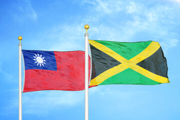 Taiwan and Jamaica two flags on flagpoles and blue sky