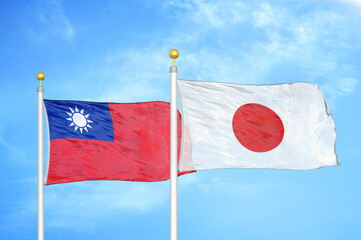 Taiwan and Japan two flags on flagpoles and blue sky