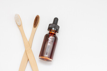 Eco bamboo brushes and oil product in a glass bottle. Selective focus. Organic, bio, natural cosmetics