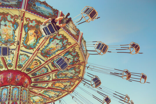 Wave Swinger ride against blue sky, vintage filter effects 
