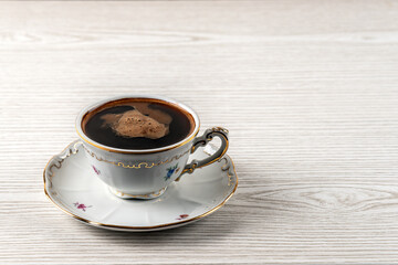 A cup of coffee on a white wooden table