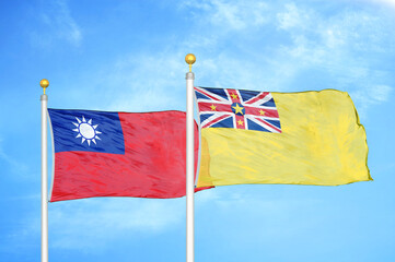 Taiwan and Niue two flags on flagpoles and blue sky