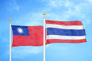 Taiwan and Thailand two flags on flagpoles and blue sky