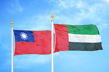 Taiwan and United Arab Emirates two flags on flagpoles and blue sky