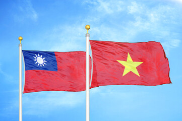 Taiwan and Vietnam two flags on flagpoles and blue sky