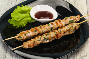 Minced pork skewer kebab with sauce