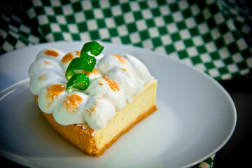 Meringue lemon tart slice in a plate 