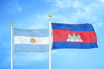 Argentina and Cambodia two flags on flagpoles and blue sky