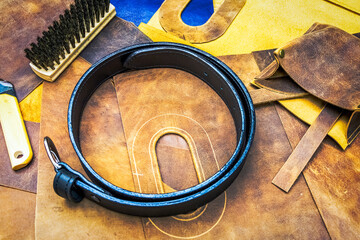 leather workshop and tools with black belt