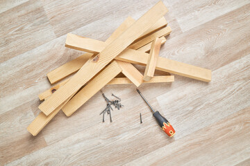 diy wood working at home. wooden planks with screwdriver. woodwork. domestic life. male person repair or fixing furniture.