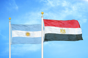 Argentina and Egypt two flags on flagpoles and blue sky