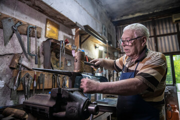 A worker works carefully with sheet metal