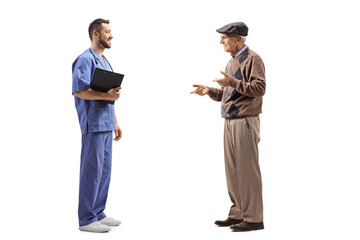 Male doctor in a blue uniform talking with an elderly gentleman