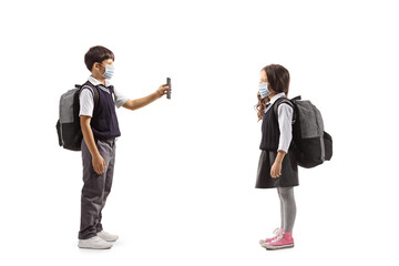 Male pupil wearing protective face mask and showing a mobile phone to a female pupil