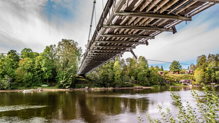 Hang a bridge over a river during the autumn in Swedish landscapes
