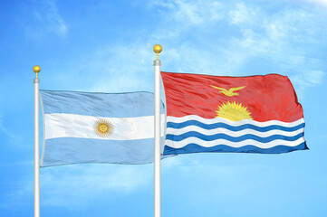 Argentina and Kiribati two flags on flagpoles and blue sky