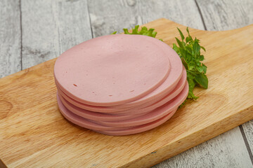 Sliced pork natural sausages over board