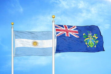Argentina and Pitcairn Islands two flags on flagpoles and blue sky