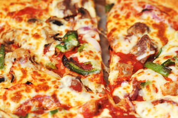 Meat pepper pizza lies on cardboard packaging