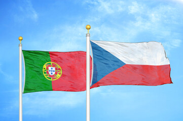 Portugal and Czech Republic two flags on flagpoles and blue sky