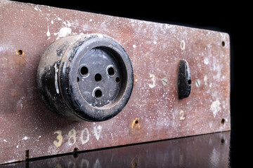 Old high voltage electric socket. Electric board with a controller.