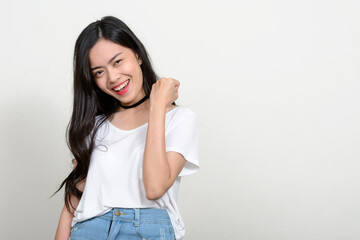 Portrait of happy young beautiful Asian woman