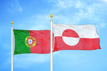 Portugal and Greenland two flags on flagpoles and blue sky