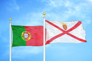 Naklejka na ściany i meble Portugal and Jersey two flags on flagpoles and blue sky