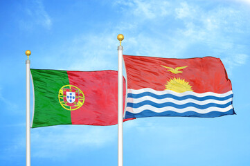 Portugal and Kiribati two flags on flagpoles and blue sky