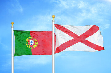 Naklejka na ściany i meble Portugal and Northern Ireland two flags on flagpoles and blue sky