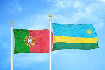 Portugal and Rwanda two flags on flagpoles and blue sky