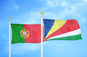 Portugal and Seychelles two flags on flagpoles and blue sky